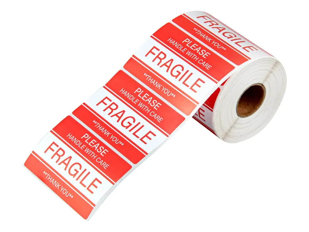 Roll of red and white FRAGILE stickers reading Please handle with care and Thank you, several labels unrolled